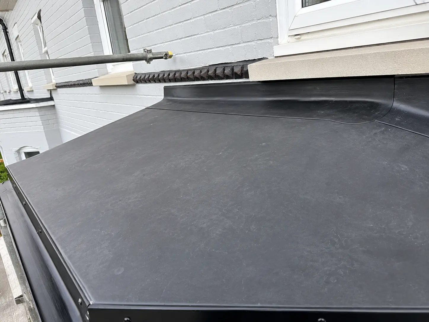 Black EPDM rubber flat roof fitted to a rear extension