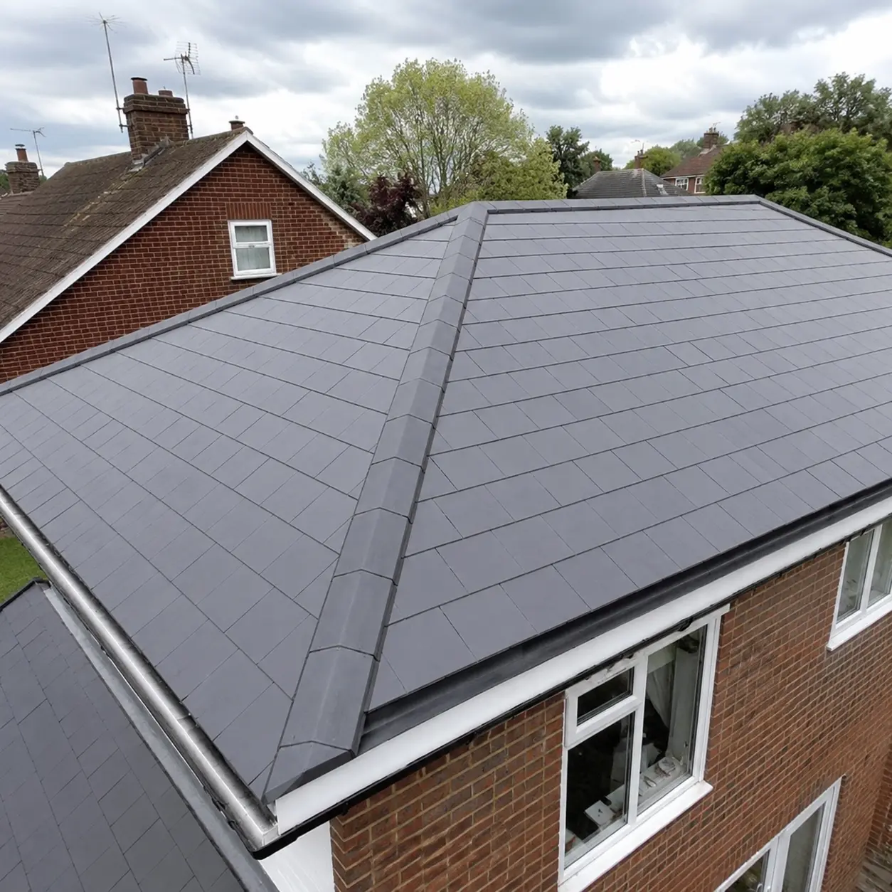 Newly installed grey tiled roof on a UK detached house in Croydon